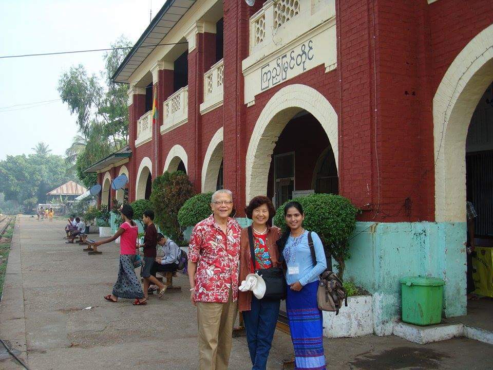 photo of three people in train station