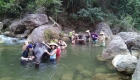 photo of seven people give bath to elephant