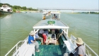 Photo of five passengers on a river boat