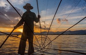 photo of a fishermen with fishing nest
