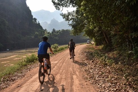 photo of two people cycling in Hpa an